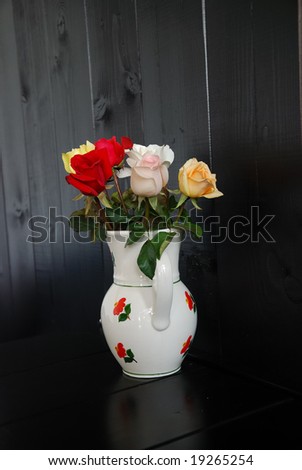 decorative vase with roses on a black background. dark  abstract