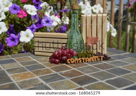 small wine bottle and trivets with flowers displayed for humor