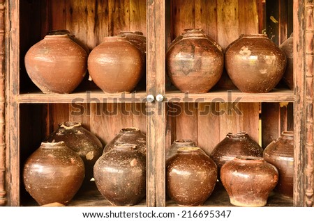 Old pottery jars in old wood shelf