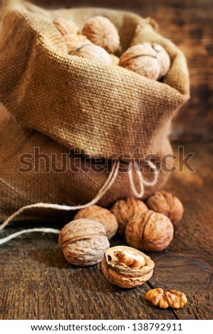 walnuts in a burlap bag on wooden