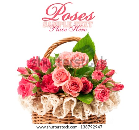 pink roses in a basket on a vintage wooden background