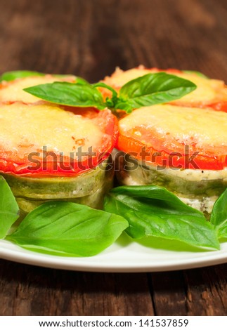 vegetarian dish of zucchini , tomato and cheese close-up