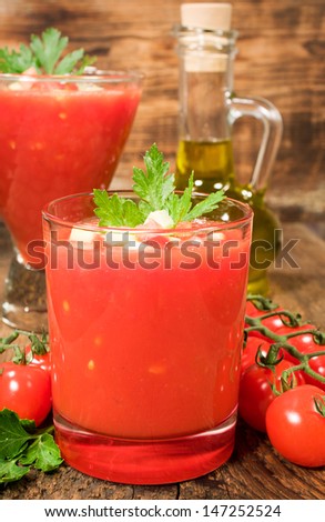 gazpacho soup with cherry tomatoes on a wooden background