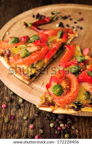mushroom pizza with spices on a wooden background