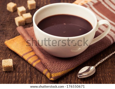 hot chocolate with cane sugar on a wooden background
