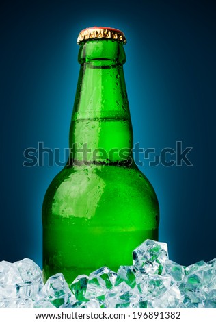 beer in a green bottle with ice cubes