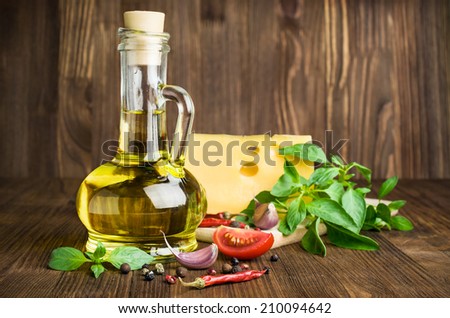Italian food.olive oil with cheese, basil and spices on a wooden