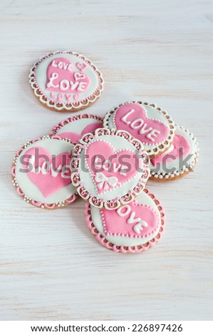 homemade cookies with pink frosting in the shape of hearts and the words \