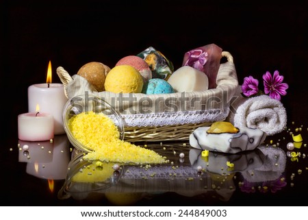 Spa. Stylish still life with candles and a set of handmade soap on a black background.