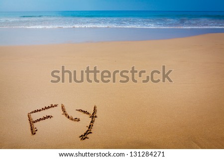 Word Fly Written in Sand, on Tropical Beach