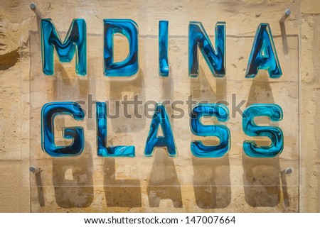 MDINA, MALTA - JULY 20: Mdina glass sign in front of a glass shop in Mdina, Malta, on July 20, 2013. Products made out of Mdina glass are known worldwide for high quality and design interpretation.