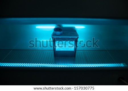 Box with danger virus content under ultraviolet light
