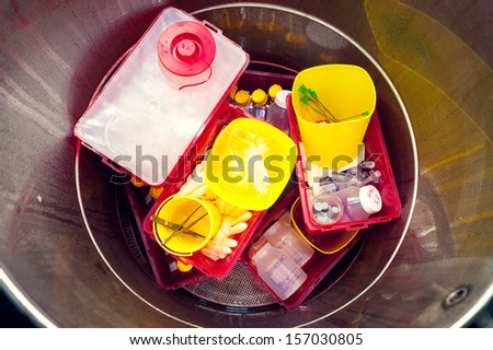Danger medical waste disposed in a garbage box Danger medical waste disposed in a garbage box
