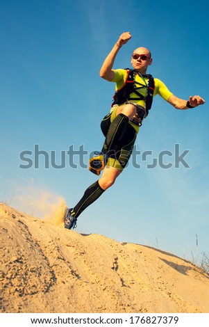 OMAN - JANUARY 30: Unidentified runner running in desert on extreme endurance marathon Transomania, on January 30, 2014. Runners reach the finish after running 300 km in mountains and desert.