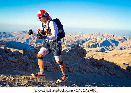 QALHAT, OMAN - JANUARY 28: Unidentified runner running in mountains near Qalhat, on January 28, 2014. Transomania is one of the most extreme marathons, 300 km of mountains and desert.