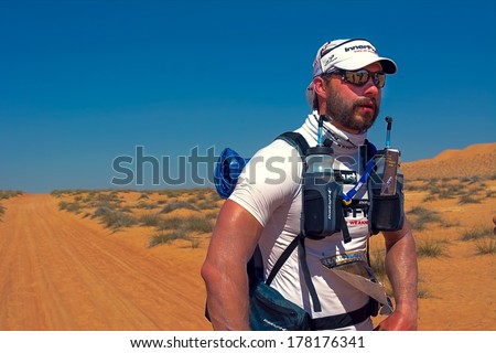 WAHIBA DESERT, OMAN - JANUARY 29: Unidentified runner resting on extreme marathon Transomania, on January 29, 2014. Runners face exhaustion, dehydration and hallucinations caused by sleep deprivation.