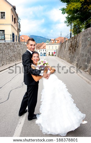 Newlyweds having fun in the middle of road