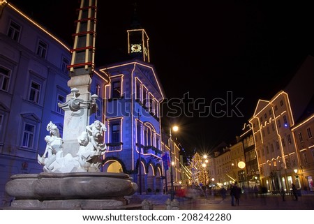 LJUBLJANA, SLOVENIA - DECEMBER 30: Robba fountain and city hall in festive lightning for Christmas and New Year\'s eve celebration with entertainment program. Ljubljana, Slovenia, on December 30, 2013