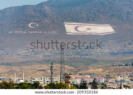 NICOSIA, CYPRUS - JUNE 3, 2014: Flag  of the Turkish Republic of Northern Cyprus overlooks the Cypriot capitol on June 3, 2014. With 805,400 square feet, it is the larger national flag in the world.