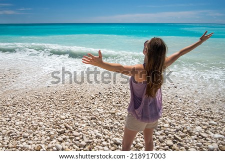 Smile Freedom and carefree woman on beach. She is enjoying serene tropical ocean nature.