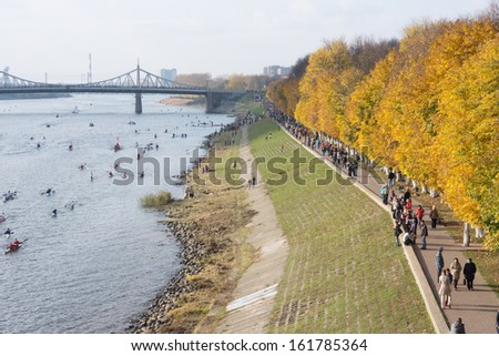 TVER, RUSSIA - OCT 11: People on the embankment Afanasy Nikitin and boats on the river Volga during the Olympic torch relay on October 11, 2013