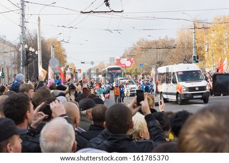 TVER, RUSSIA - OCT 11: People welcome torchbearer Vladimir Solovyov, who took the Olympic flame in Tver on October 11, 2013. Tver became 8th the city which the Olympic flame visited in Russia