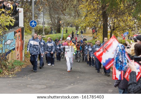 TVER, RUSSIA - OCTOBER 11: Torchbearer carries the Olympic flame October 11, 2013, Tver. In Tver, in the Olympic torch relay was attended by 110 torchbearers