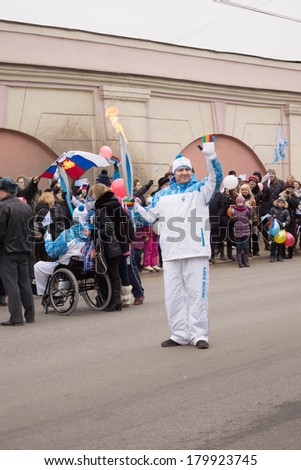 TVER, RUSSIA - MAR 2, 2014: Torchbearer with torch in hand on the Paralympic Torch Relay. In the Paralympic Torch Relay in Tver involved 100 torchbearers
