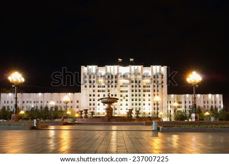 KHABAROVSK, RUSSIA - MAY 16, 2014: Administration building on the central square named after Lenin with night illumination. This is a large white building with a length equal to the length of square
