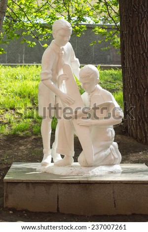 KHABAROVSK, RUSSIA - MAY 7, 2014: Statue of two boys with toy airplane in the Alley of park sculpture. Alley opened in 2008 as part of the museum named after Grodekov