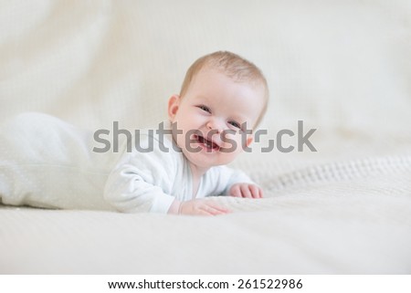 Laughing baby on bed