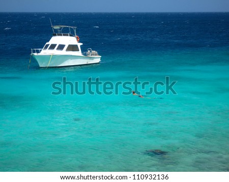 Snorkeling in Caribbean Sea with dive boat, Curacao, Netherlands Antilles,