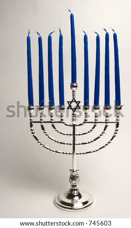 Silver menorah, with 9 blue candles. Unlit.