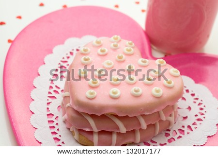 Valentine pink heart cookies stacked on a pink plate