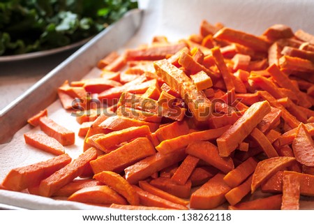 Large pan of fresh cooked sweet potato french fries, fresh out of frying oil
