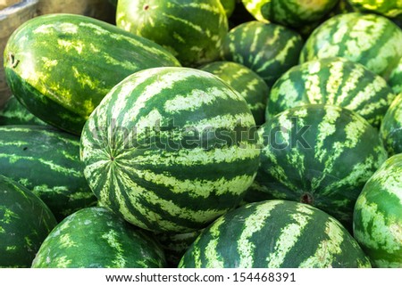 Fresh locally grown display of watermelons for sale at local farmers market
