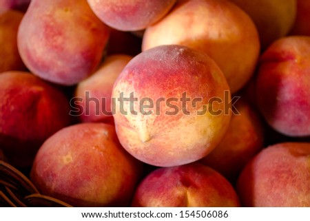 Close up of basket of ripe yellow peaches for sale at orchard store