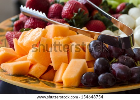 Close up of hors d\'oeuvres of assorted cheeses and fruits