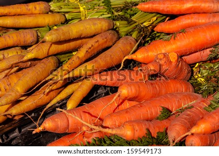 Display of fresh organically grown carrots for sale at local farmers market