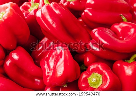 Display of locally grown red bell peppers for sale at local farmers market