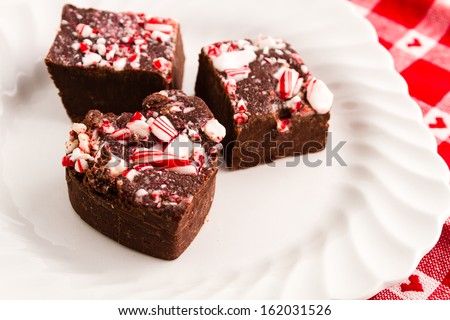 Candy cane fudge sitting on white plate and heart napkin