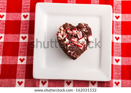 Heart shaped peppermint fudge sitting on square white plate
