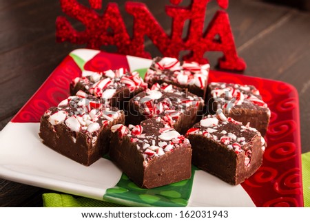 Colorful holiday plate filled with candy cane fudge and Santa sign