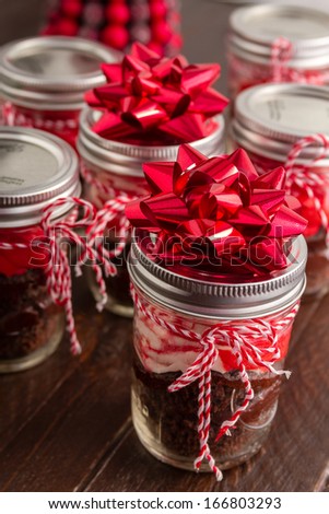 Chocolate peppermint cupcakes in a jar with red and white bakers twine and red bows