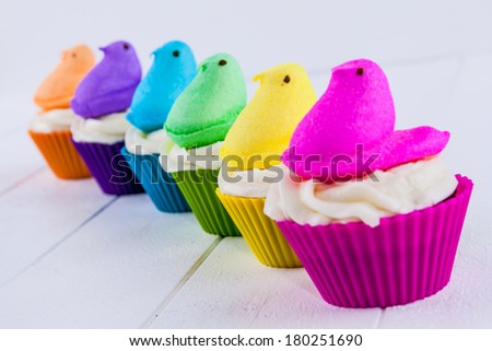 Brightly colored Peeps marshmallow Easter cupcakes arranged in rainbow Brightly colored Peeps marshmallow Easter cupcakes arranged in rainbow