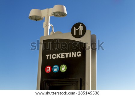 Train depot ticketing signs in early morning sunlight