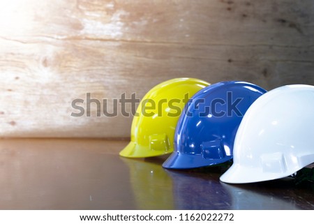 Engineer, electrician and worker 's helmet color as White, Blue and Yellow , PPE  (Personal Protective Equipment) very importance for health protection. Safety at work concept