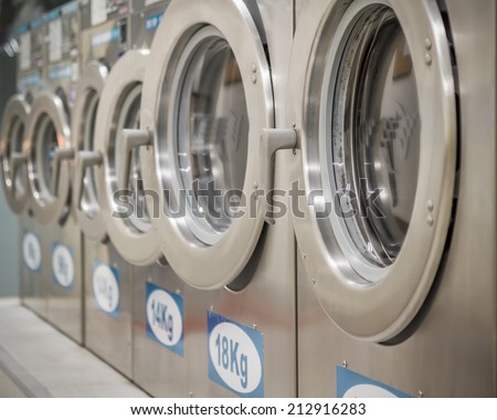 Row of washing machines at a public laundrette