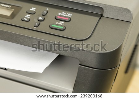 Close-up of printer printing documents on paper