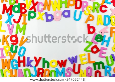 Frame of Colorful alphabet magnets on a whiteboard